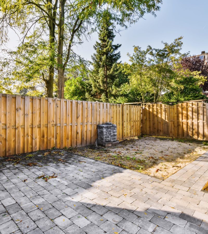 Nice courtyard of the house with beautifully laid tiles and a fence